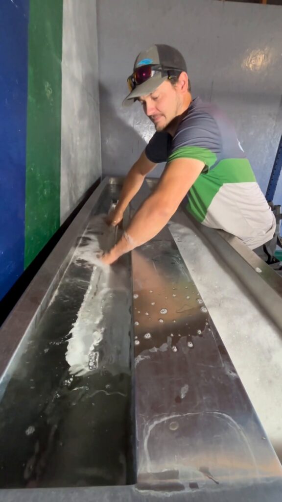 Technician cleaning blinds in an ultrasonic tank