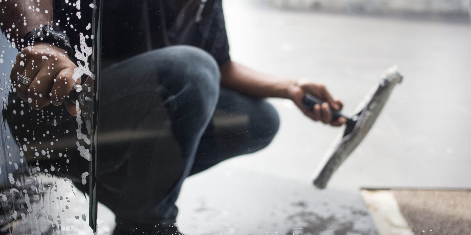 Cleaning,Windows,With,A,Squeegee